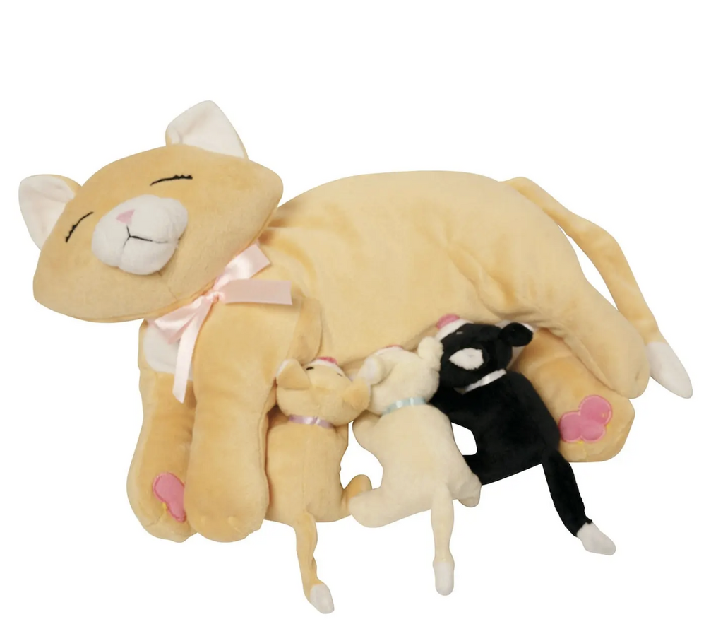 A stuffed animal mama cat named Nina lying on her side with three nursing kittens attached to her side. Nina is a light orange cat with a pink ribbon tied around her neck. Her kitties are black, cream and matching orange. 