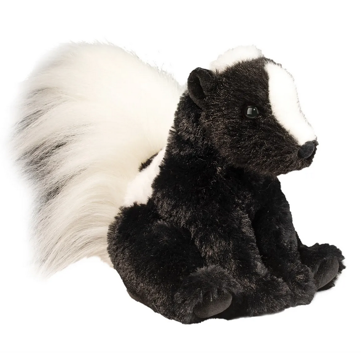 Odie Skunk stuffed animal in a seated position with shiny black fur, a white stripe from his nose to his fluffy tail. 