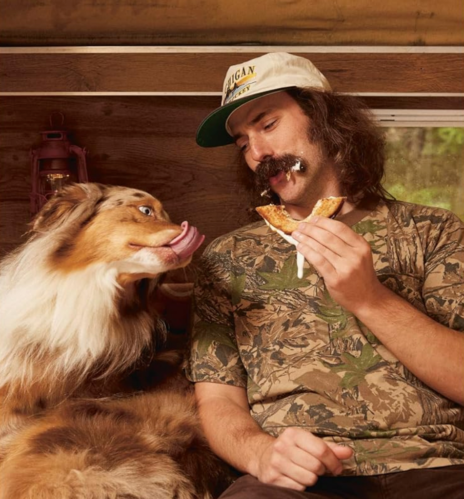Picture of the author Fritz with one of his dogs enjoying a Fluffernutter made from a recipe in the book.