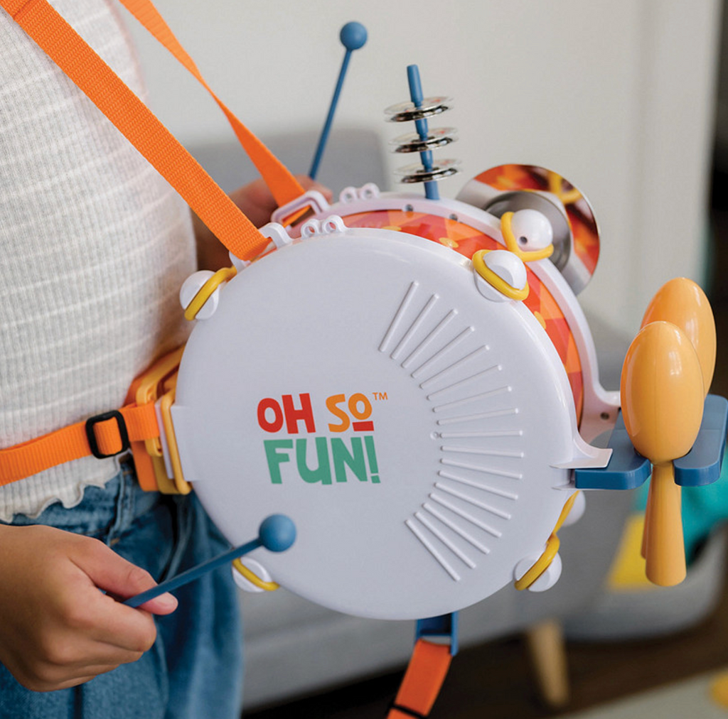 Image of the One Kid Band being worn by a child playing the drum.