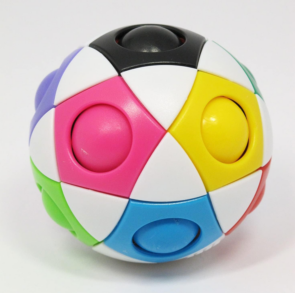 Closeup of Orbo puzzle. Orbo is a white handheld round puzzle with brightly colored sections that have a pop up ball of the same color.