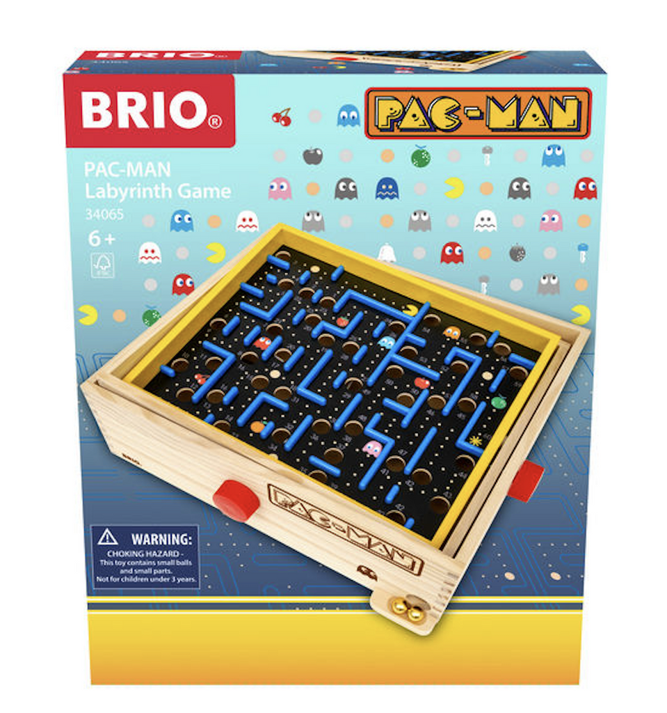 Colorful box containing the Brio Pac-Man Labyrinth maze game. The front of the box has a picture of the wooden box with tilting maze that recreates the retro arcade game Pac-Man with a challenging maze with pac-dots, ghosts and fruits positioned all around the board. 