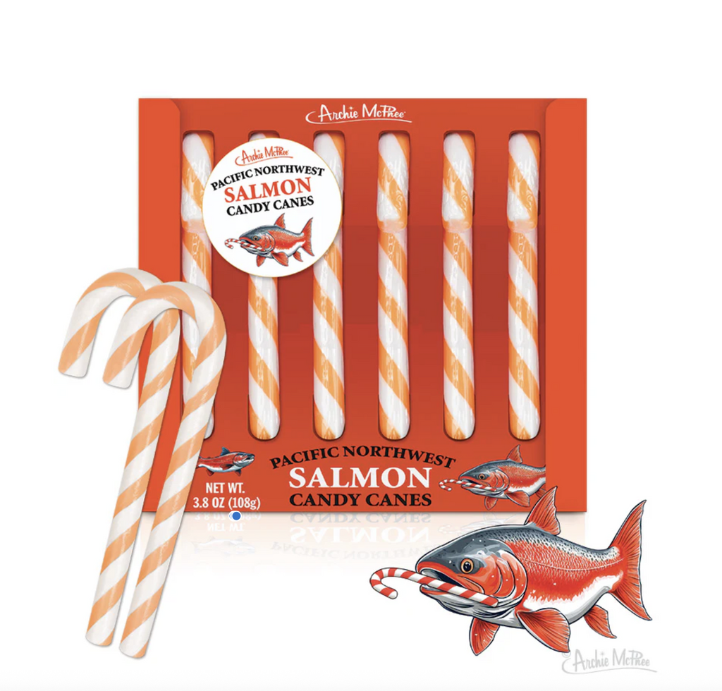Funny salmon flavored candy canes in a red box on white background.