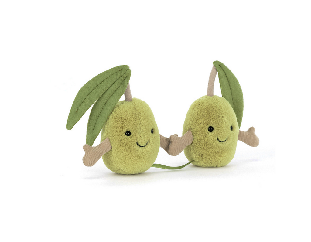 Two green plush olives holding hands on a white background.