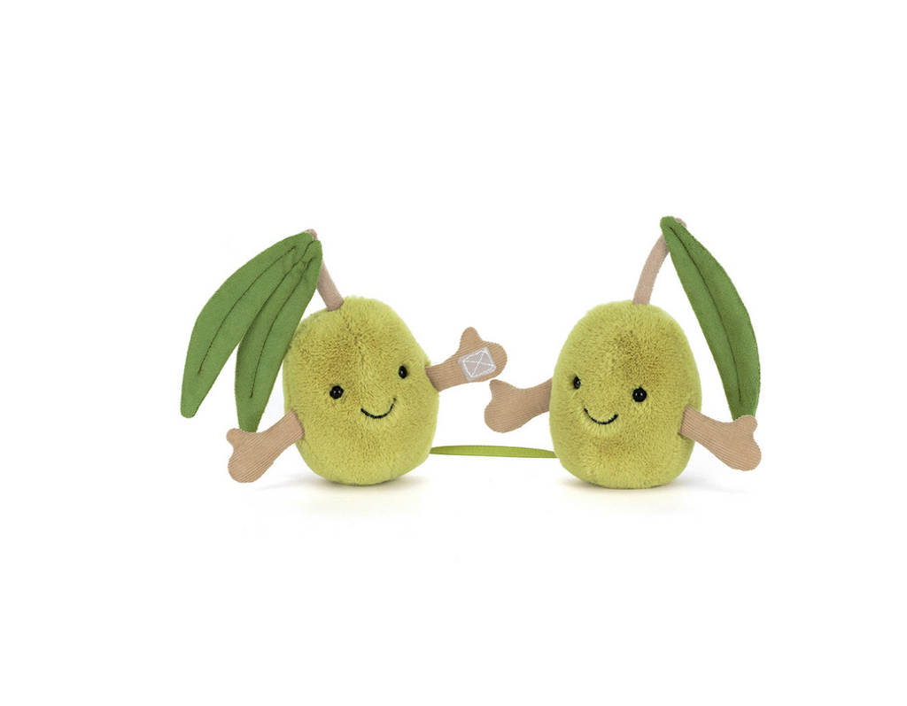 Two small olive plush toys with smiling faces, green leaves, and tan arms, shown on a plain white background.