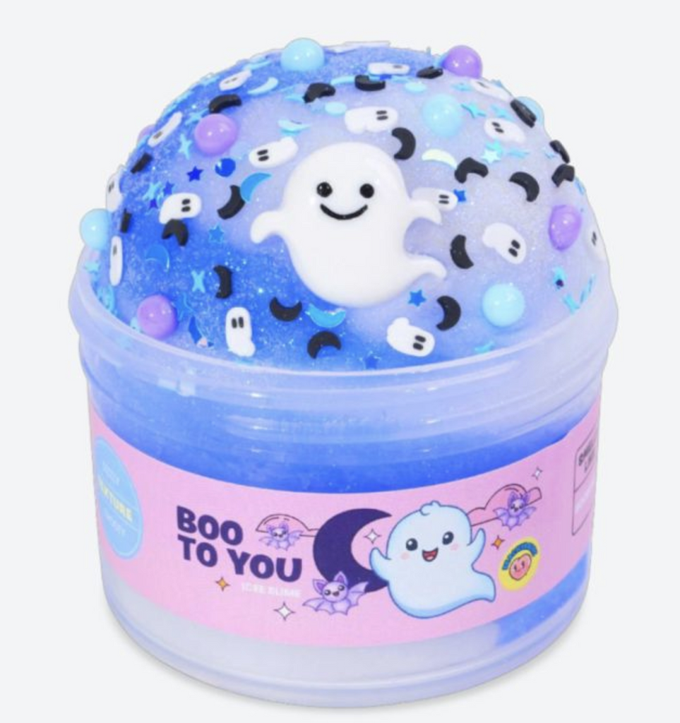 Boo To You is blue and white icee slime in a clear container with ghost and moon charms, mix-ins and sprinkles. 