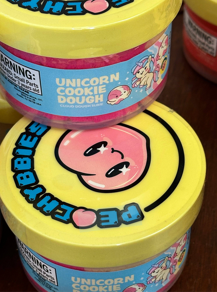 Two containers of Peachybbies 'Unicorn Cookie Dough' slime stacked on one another. 