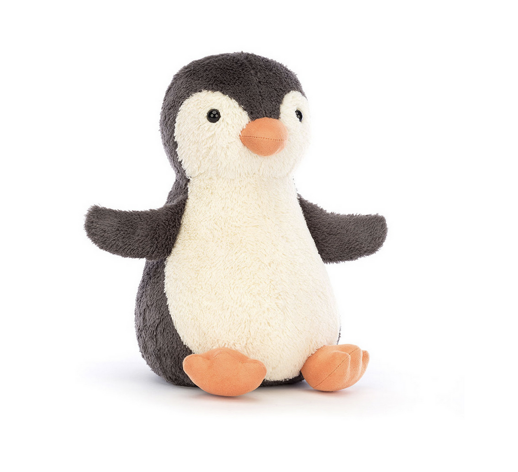 White and black plush seated penguin.