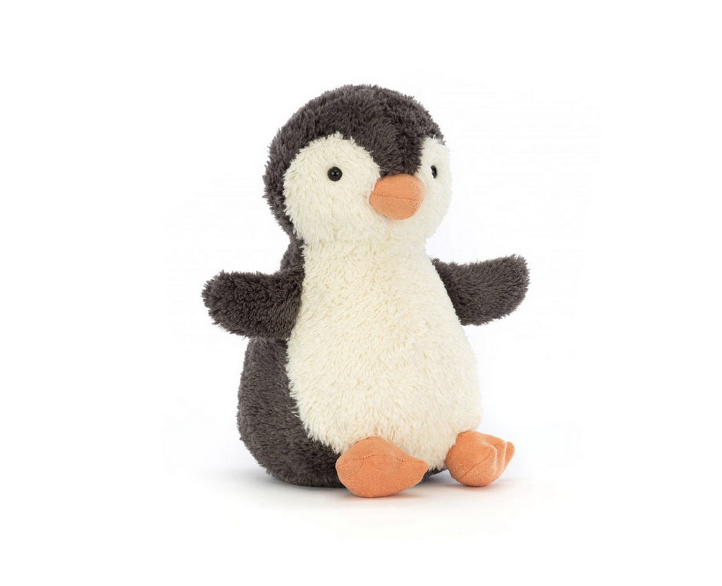 Black and white nubby plush penguin seated.