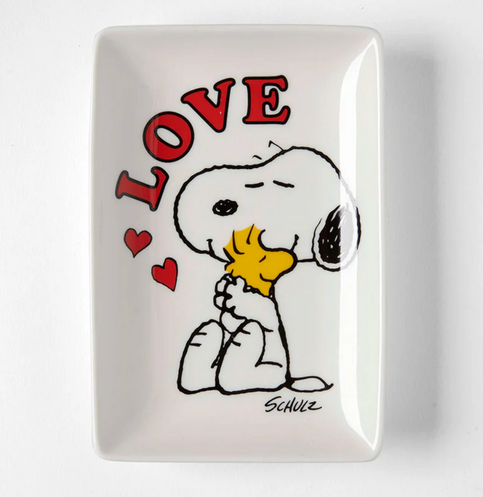 White china trinket tray with illustrationn of Snoopy and Woodstock hugging. The word Love is written in red letters. 