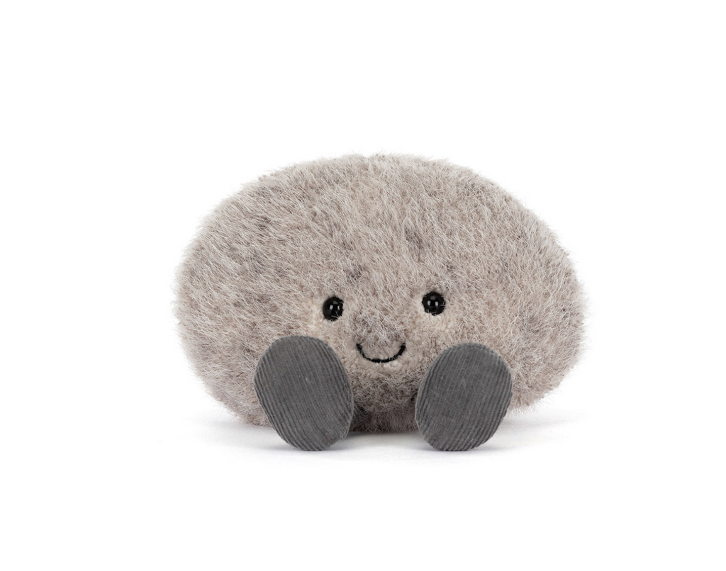 Small grey happy faced plush pebble on a white background.