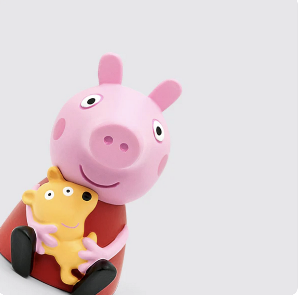 Peppa Pig Tonie figure shows Peppa in a red dress holding her yellow teddy bear.