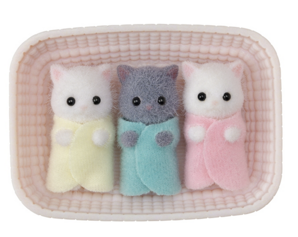 Calico Critters Persian Cat Triplets figures in a pink cradle.