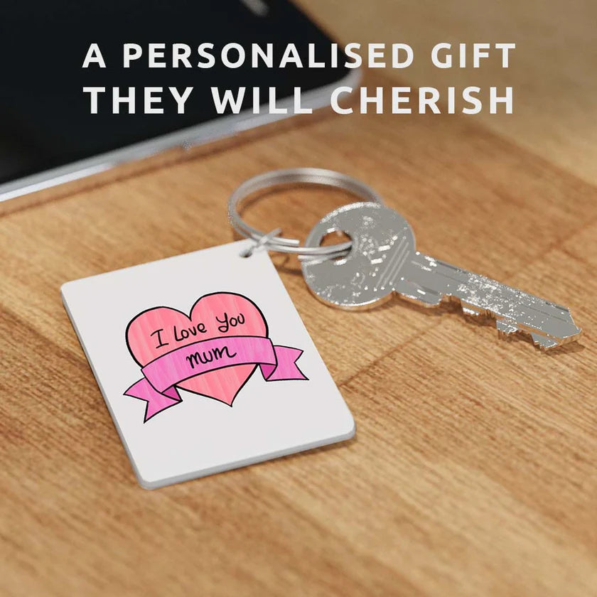 A keychain made with the Shrink Keychain Kit with a pink heart with purple banner that reads "I Love You Mum"