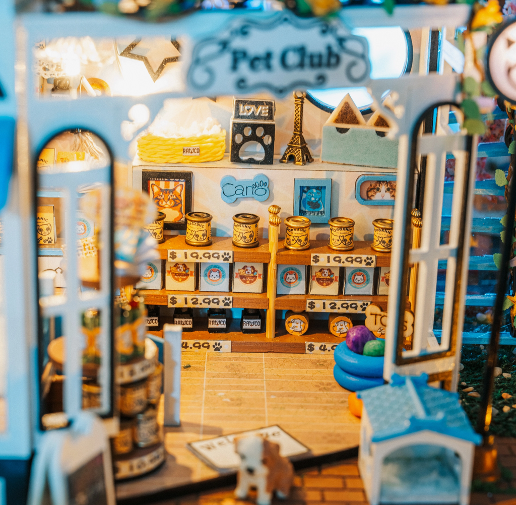 Inside shot of the Pet Club DIY miniature kit showing dog food and treats on a shelf, lights, walls, pet toys, and more.