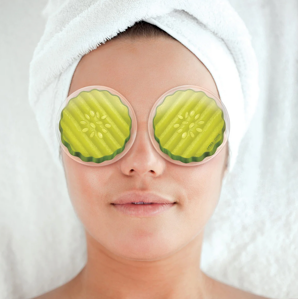 A person relaxing with their hair in a towel and the Pickles eye gel pads over their eyes. 