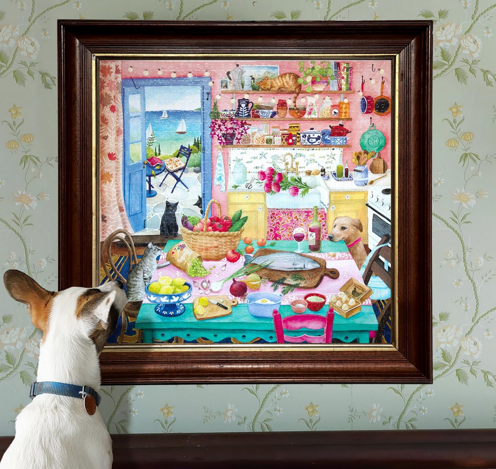 The completed Pink Kitchen puzzle framed and hung on a wall. A dog is admiring it.