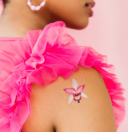 Pink orchid temporary tattoo applied to shoulder. 