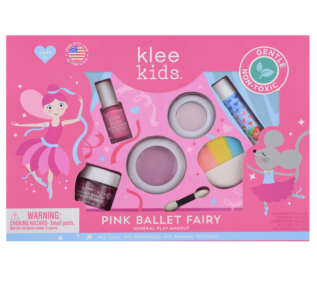 Klee Kids Pink Ballet Fairy kids make up set packaged in a bright pink box with  illustrated ballerinas. There are a series of windows in the box showing each item included in the set such as, lip shimmer, pink blush and eye shadow, a rainbow makeup brush and sponge applicator, pink nail polish and pink glitter. 