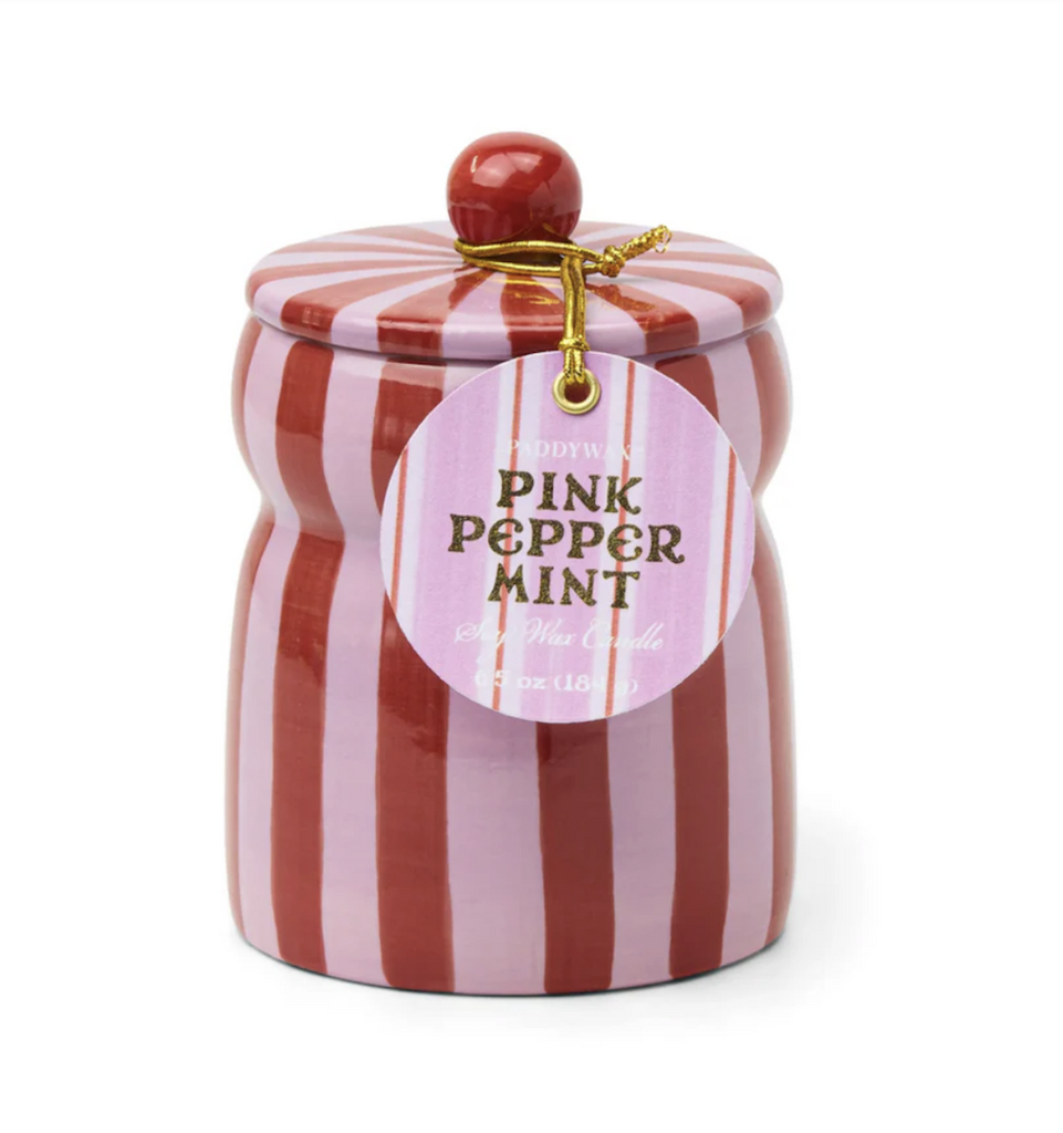  Pink Peppermint scented candle in a hand-painted striped vessel of red and pink with a matching lid. There is a tag hanging from the lid that reads "Pink Peppermint Soy Wax Candle"
