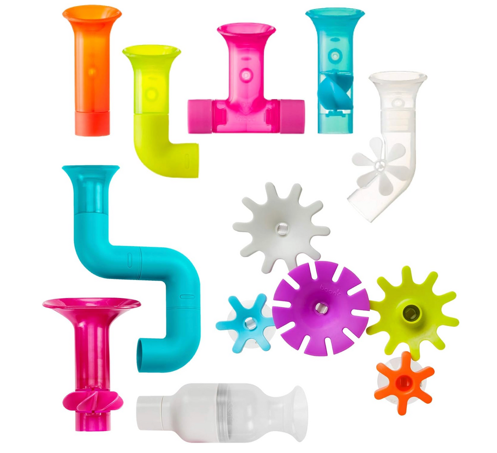 Colorful gears, tubes and connector pieces laid out on a white background. 