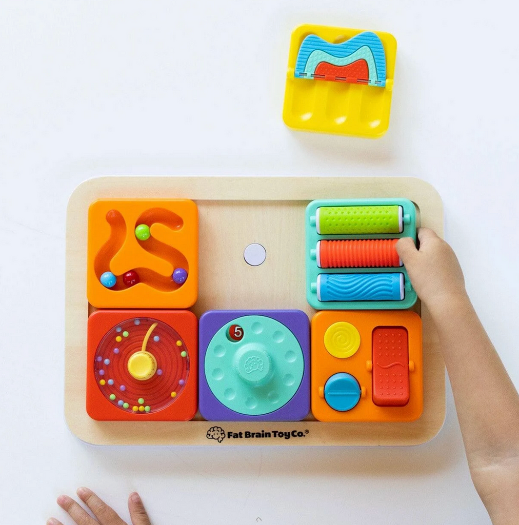 The Play Tab Board with five different sensory tiles attached for baby to play with. 