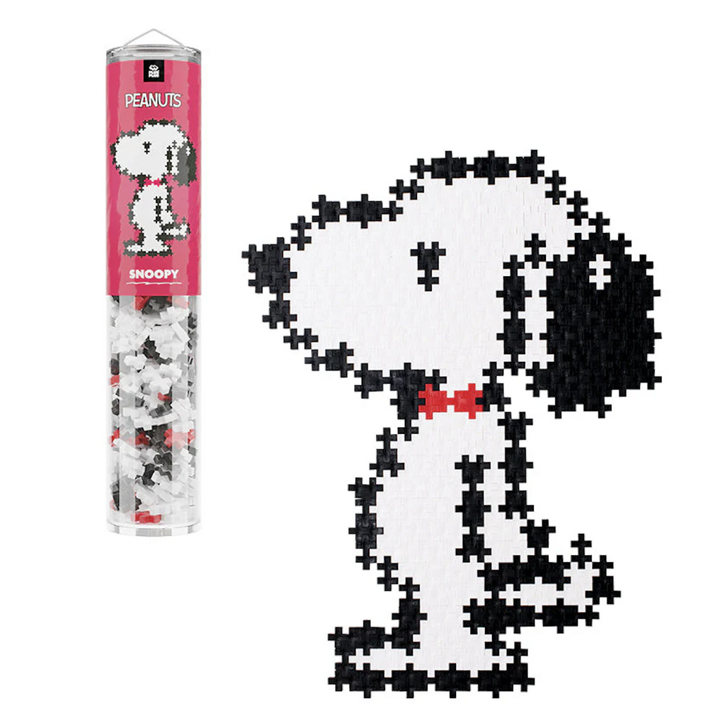 A black and white Snoopy puzzle made using the Plus Plus Puzzle By Number Snoopy set. The pieces are contained in a clear tube that has a picture of Snoopy on a red background. 