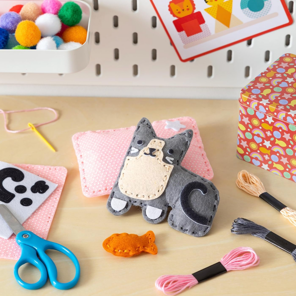 A little cute cat plush toy made with the  pre-shaped felt pieces, stuffing, embroidery thread, and self-adhesive felt stickers that are included in the kit. 