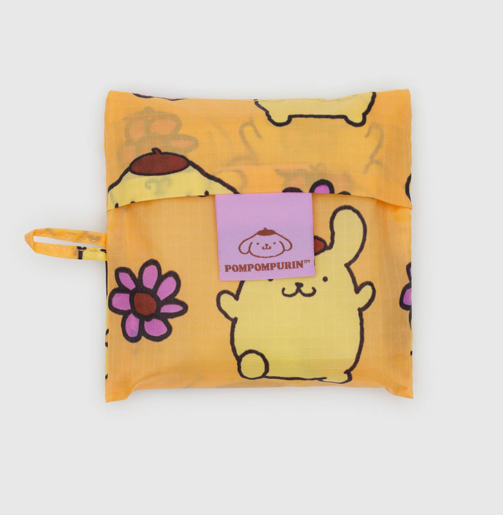 Yellow  standard Baggu bag folded into it's flat 5 x5  storage pouch with a Pompompurin pattern. 