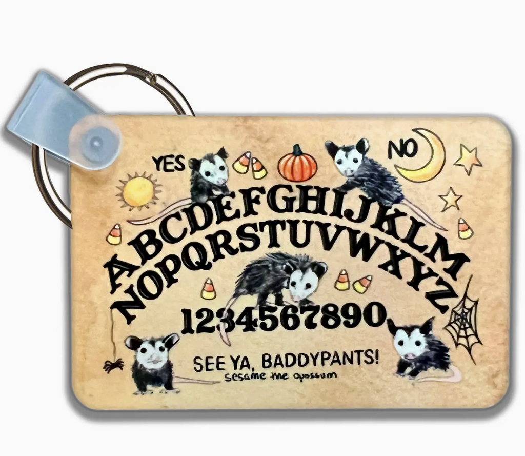 Mini Ouija board with possums drawn on it. 