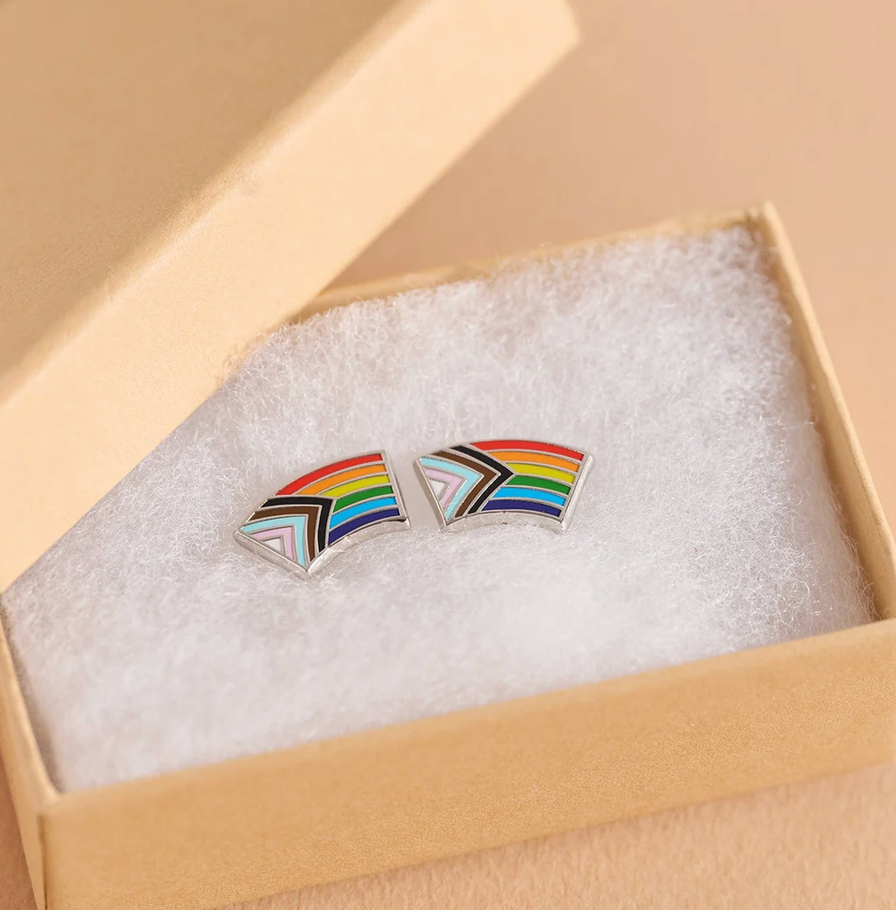 The Progress Pride Flag earrings packaged in a gift box. 