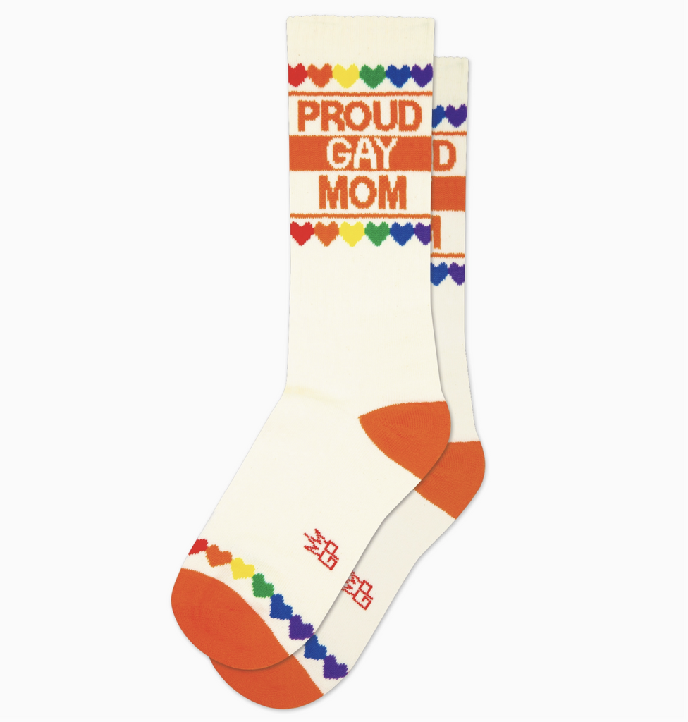 White tube socks with rainbow colored hearts and orange stripes that read "Proud Gay Mom"