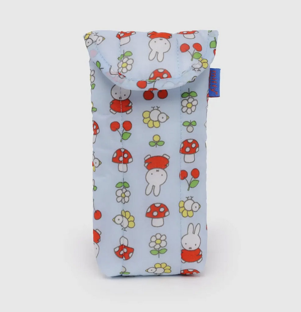 Baggu Puffy Glasses Sleeve in the Garden Miffy pattern which has a light blue background with images of Miffy wearing a red dress, mushrooms, flowers and cherries repeated all over the glasses case. 