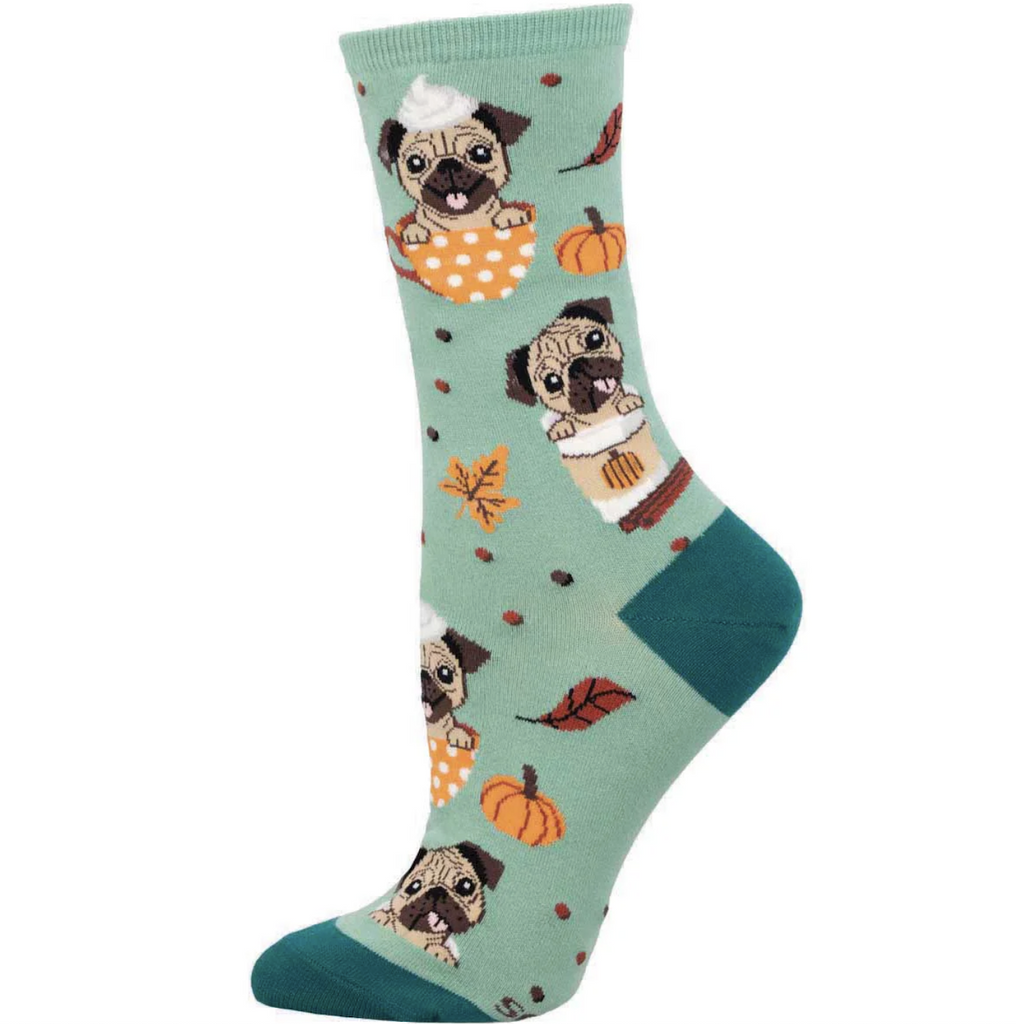 Mint green colored socks with cute pugs peeping out of a cozy pumpkin latte cup with pumpkins and fall leaf accents. 