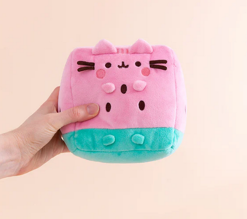 The Pusheen Watermelon plush held in a hand. 