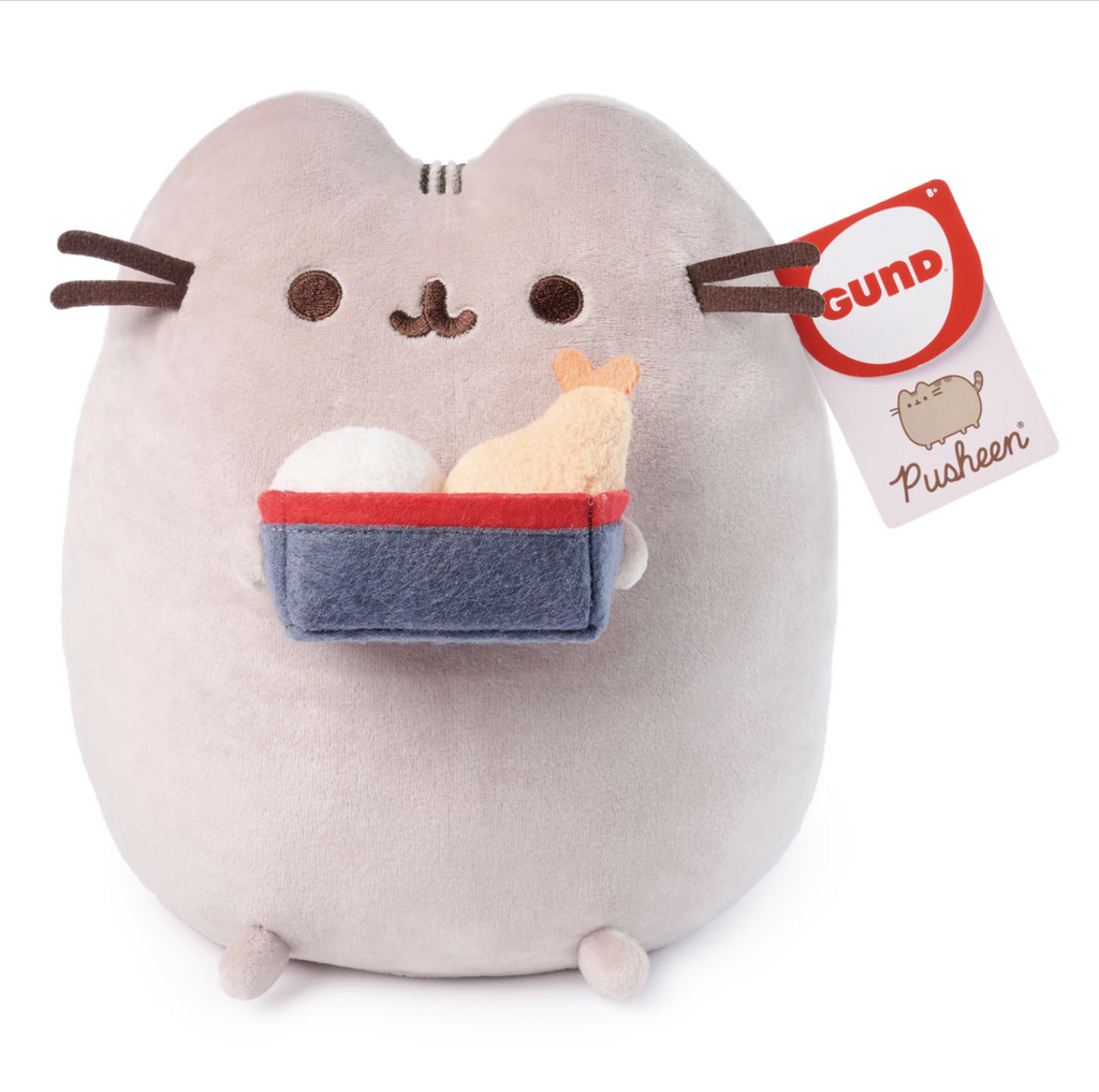 Plush Pusheen cat with soft gray fur and holding a blue bento box with fluffy rice and tempura shrimp.