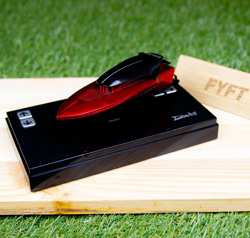 The Ruby RC Mini Speed Boat on it's charger.