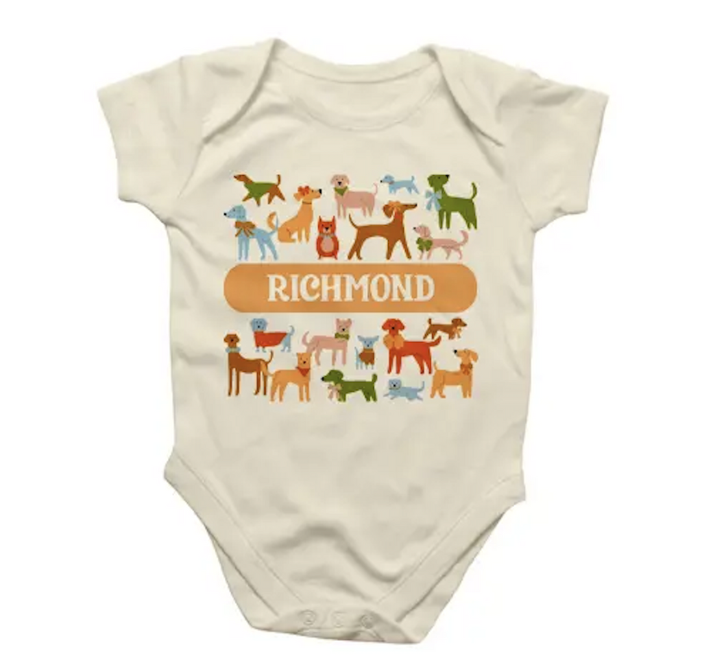 Baby snap suit with illustrated image of many cool dogs and Richmond written on the front. Size x-large 12-18 months. 
