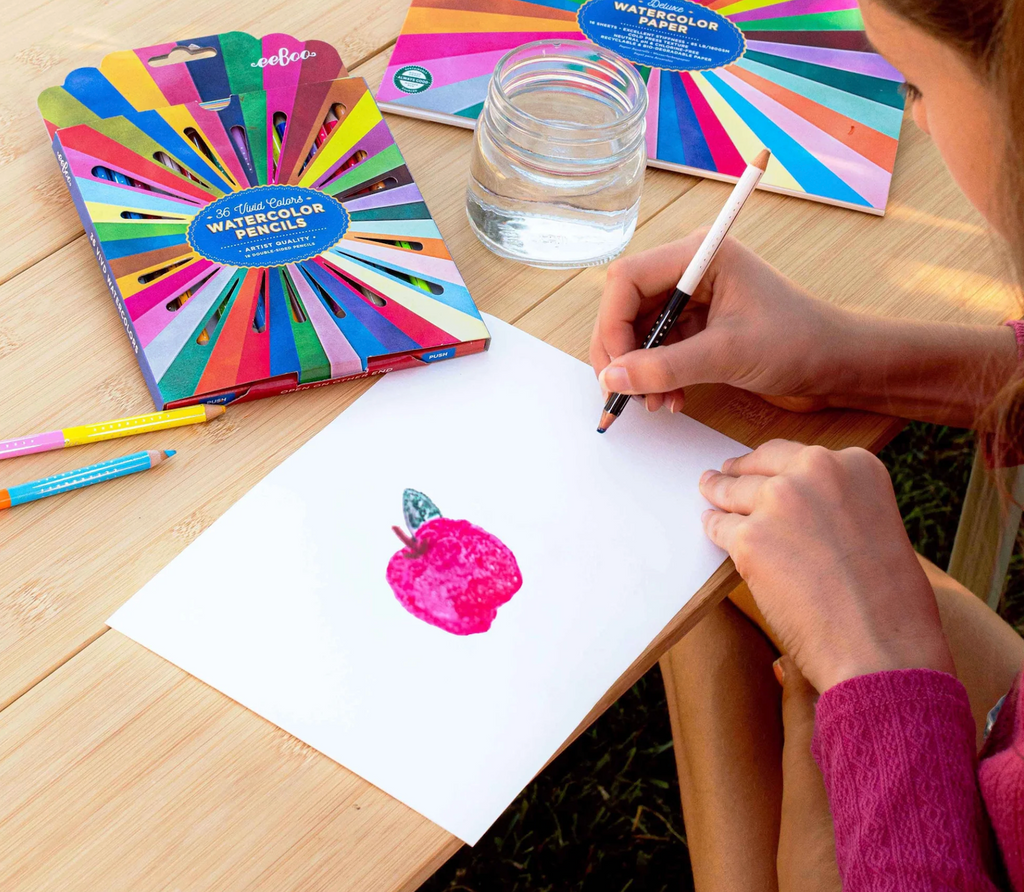 Someone using the Rainbow Watercolor Pencils (sold separately) to draw on a sheet from the Rainbow Watercolor Pad. 