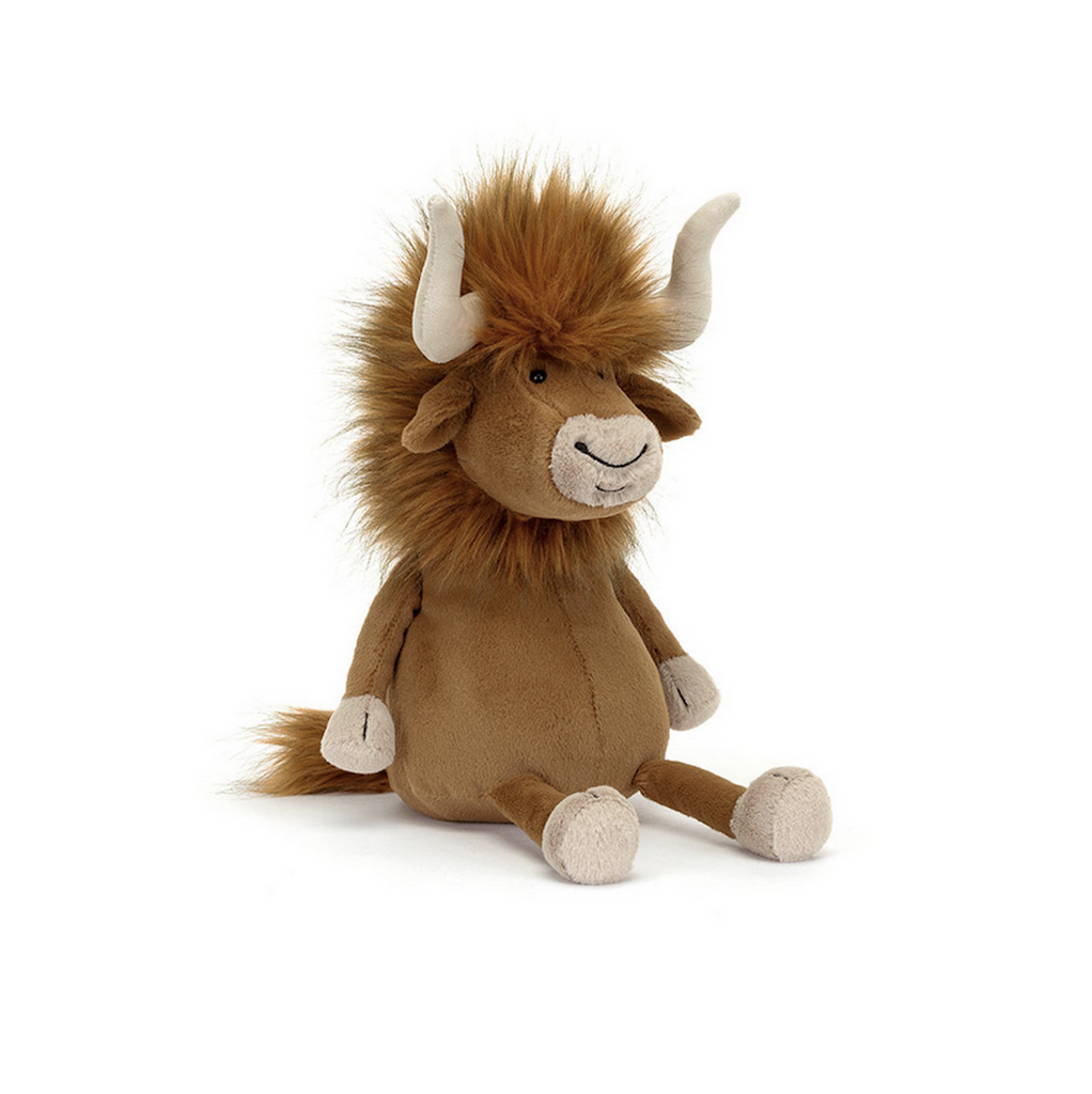 Ramone Bull sitting up and facing front with his long horns and fuzzy crown of fur. 