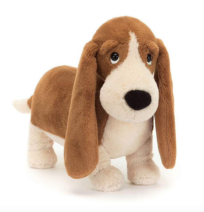 Full front view of Randall Basset Hound plush dog. His long brown ears almost the ground because his little legs are so short. His droopy eyes add to his cuteness. 