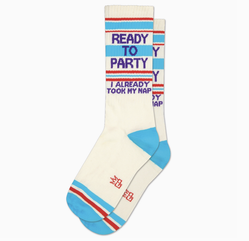White tube socks with red and baby blue stripes that read Ready To Party, I ALready Took My Nap" in blue letters.