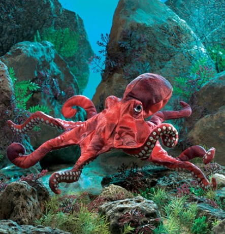 Red Octopus plush puppet in an undersea backdrop. 