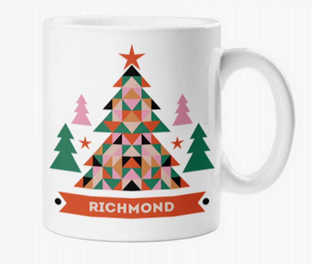 White ceramic mug with colorful graphics of a geometric Christmas tree design that has a red banner that reads Richmond.