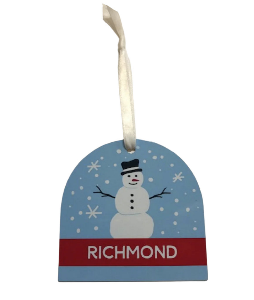 Metal ornament with white ribbon for hanging that has an illustration of a snowman on a blue background with snow flakes falling and a red banner that reads "Richmond"