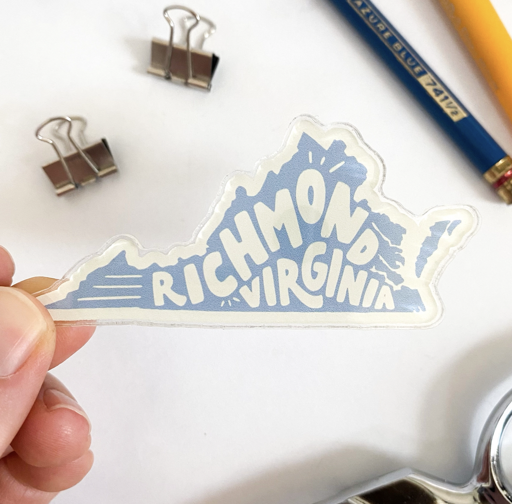 Acrylic magnet featuring hand lettering that reads 'Richmond, Virginia' inside of the shape of Virginia; in cream and light blue.