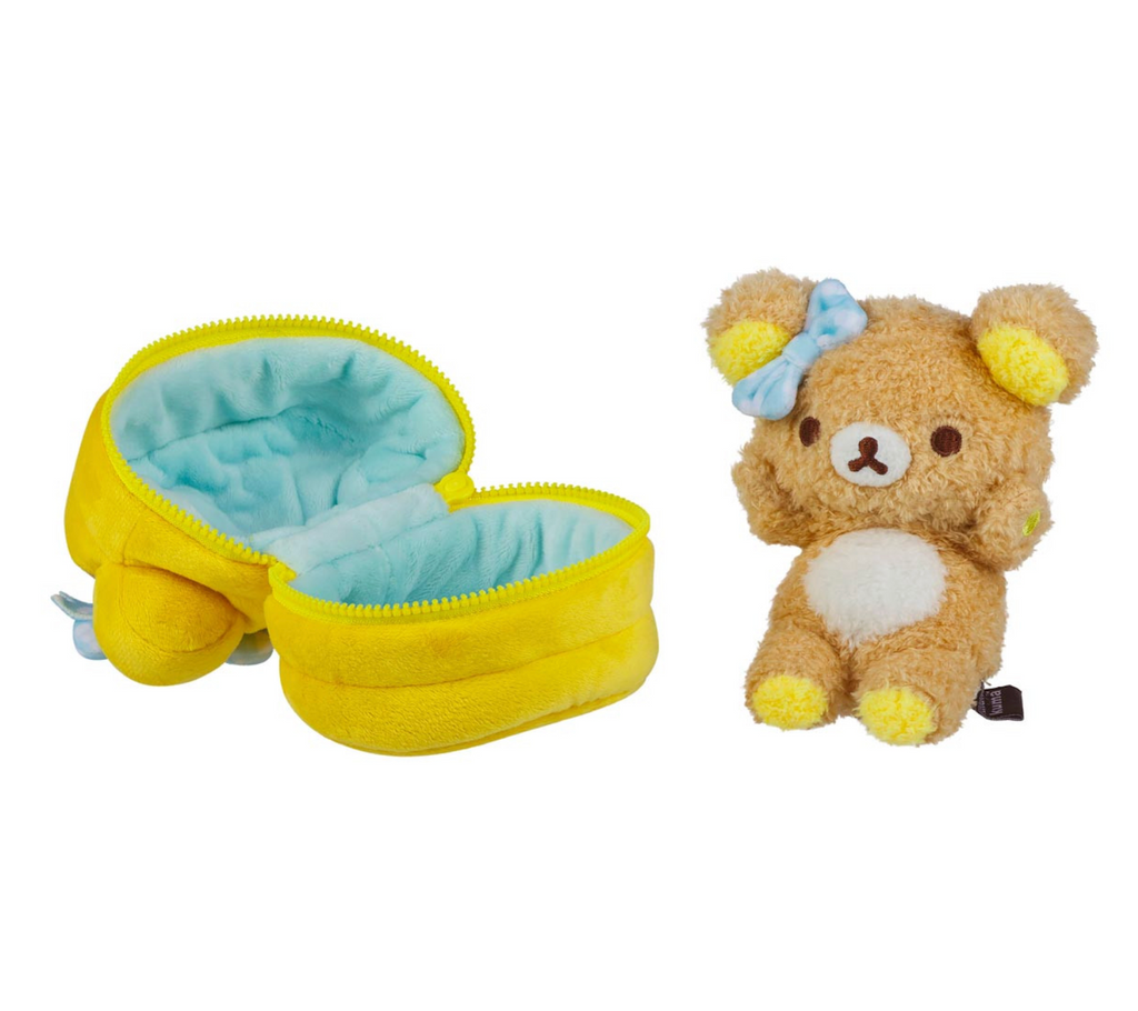 The Rilakkuma plush doll in a sitting pose beside the plush pancakes it is stored in. 