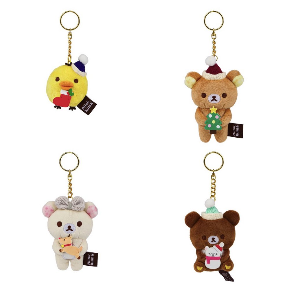 Four plush keychain figures that are possible to get from the Rilakkuma Blind Box Holiday Series. Rilakkuma characters wearing festive hats and holding holiday themed items. 
