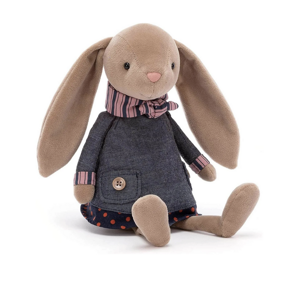 Riverside Rambler Rabbit stuffed animal from Jellycat. Sitting up and facing forward wearing their denim jacket and scarf. 