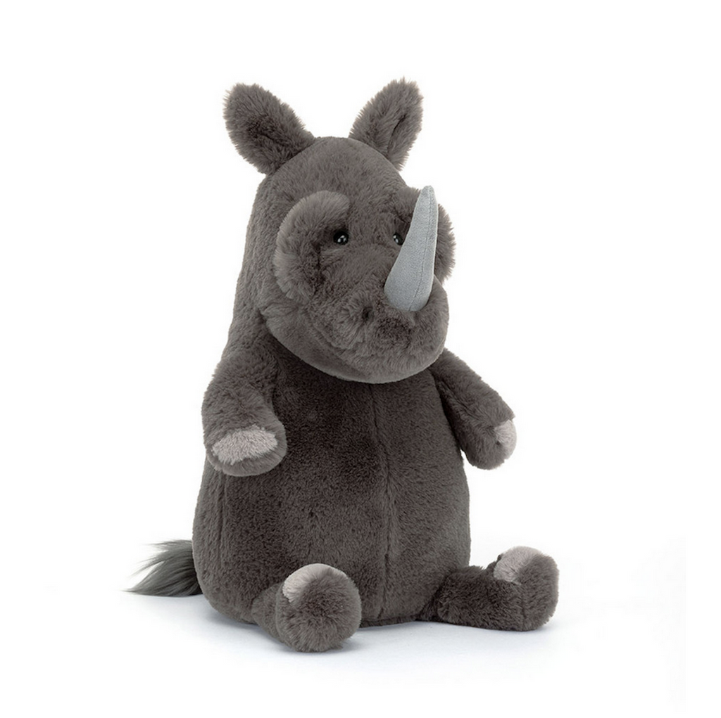 Roderick Rhinoceros stuffed animal sitting up  and facing forward with his horn prominently on his face. 